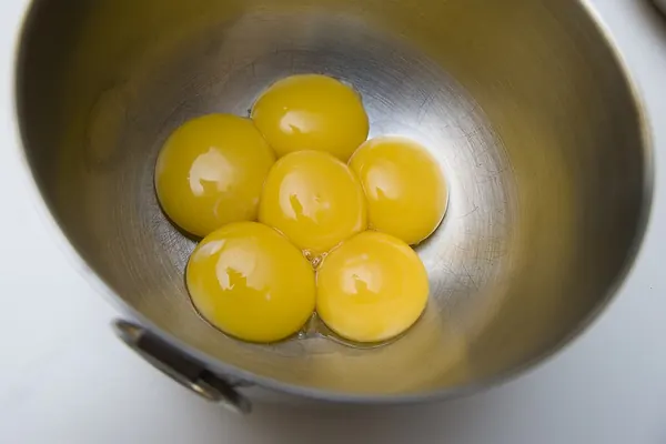 Egg yolks in a steel bowl, a common food source of choline