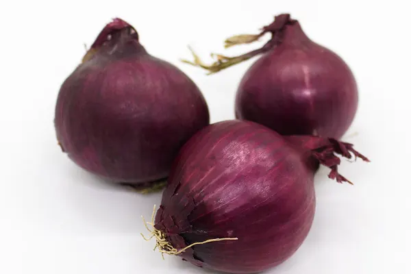 Three red onions, a common food source of quercetin